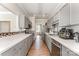 Well-equipped kitchen with stainless steel appliances, tile backsplash, and ample cabinet space at 7642 Rolling Meadows Ln, Huntersville, NC 28078