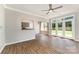 Open living area with hardwood floors, large windows, and seamless connection to the kitchen at 7642 Rolling Meadows Ln, Huntersville, NC 28078