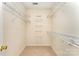Walk-in closet with wall-mounted shelving, carpeted flooring, and ample storage at 7642 Rolling Meadows Ln, Huntersville, NC 28078