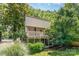 Two-story townhouse with a private balcony surrounded by lush trees, offering a serene outdoor living space at 7900 Horse Chestnut Ln, Charlotte, NC 28277