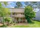 Two-story home showcasing a spacious deck, walkout basement, and a lush green backyard at 7928 Horse Chestnut Ln, Charlotte, NC 28277