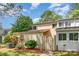 Charming townhome featuring a fenced entryway, lush landscaping, and a well-maintained lawn at 7928 Horse Chestnut Ln, Charlotte, NC 28277