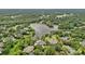 Aerial view of homes surrounding a serene lake, showcasing neighborhood at 8800 Covey Rise Ct, Charlotte, NC 28226