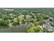 Aerial view of estate showcasing property, lake frontage, and lush landscaping at 8800 Covey Rise Ct, Charlotte, NC 28226