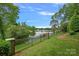 Lush backyard and lake view with well-maintained lawn and iron fence at 8800 Covey Rise Ct, Charlotte, NC 28226