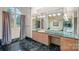 An elegant bathroom with a marble countertop, and plenty of light at 8800 Covey Rise Ct, Charlotte, NC 28226
