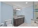 A blue bathroom provides a toilet, and an elegant stone countertop, and a glass shower at 8800 Covey Rise Ct, Charlotte, NC 28226