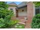 Charming front entrance with brick steps, covered porch, and manicured landscaping at 8800 Covey Rise Ct, Charlotte, NC 28226