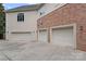 Spacious three-car garage with ample parking and exterior lighting at 8800 Covey Rise Ct, Charlotte, NC 28226