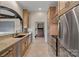 Gourmet kitchen features stainless steel appliances, granite countertops and custom cabinetry at 8800 Covey Rise Ct, Charlotte, NC 28226