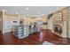 This kitchen has a large island, brick fireplace, granite countertops, hardwood floors, and modern appliances at 8800 Covey Rise Ct, Charlotte, NC 28226