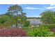 Scenic lake view from property featuring lush landscaping and mature trees at 8800 Covey Rise Ct, Charlotte, NC 28226