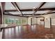 Spacious living room with hardwood floors, wooden beams and beautiful views of the lake at 8800 Covey Rise Ct, Charlotte, NC 28226