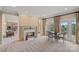 Cozy living room with marble fireplace, large windows, and comfortable seating at 8800 Covey Rise Ct, Charlotte, NC 28226