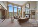 Bright and airy living room with large arched windows, fireplace, and neutral decor at 8800 Covey Rise Ct, Charlotte, NC 28226