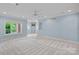 A spacious living room with light blue walls, white trim, recessed lighting, and carpet at 8800 Covey Rise Ct, Charlotte, NC 28226