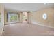 Living room with carpeted floors, a fireplace, columns, lots of natural light, and a view of the property at 8800 Covey Rise Ct, Charlotte, NC 28226