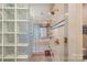 A bathroom shower offers glass block, blue tile, and gold fixtures at 8800 Covey Rise Ct, Charlotte, NC 28226
