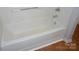 Bathroom showing tub with shower with white tile surround at 9139 Charminster Ct, Charlotte, NC 28269