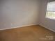 Bedroom featuring neutral walls, window, and carpeted flooring at 9139 Charminster Ct, Charlotte, NC 28269