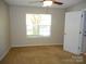 Bedroom featuring neutral walls, window, ceiling fan, and carpeted flooring at 9139 Charminster Ct, Charlotte, NC 28269