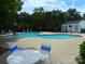 Enjoy the community pool with a large sunning deck, lounge chairs, and convenient restroom and changing facility at 9139 Charminster Ct, Charlotte, NC 28269
