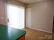 Bright dining area with sliding glass door and view to the kitchen at 9139 Charminster Ct, Charlotte, NC 28269