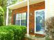 Close up of the front door of a brick townhouse, showing well-kept landscaping at 9139 Charminster Ct, Charlotte, NC 28269