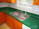 Close-up of kitchen sink and laminate counter, adjacent to dishwasher and storage at 9139 Charminster Ct, Charlotte, NC 28269