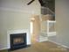 Cozy living room with fireplace, staircase, ceiling fan, and neutral carpet at 9139 Charminster Ct, Charlotte, NC 28269