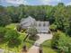 Stunning aerial view of a landscaped home with an attached three car garage behind a black gated fence at 9202 Arlington Hills Dr, Mint Hill, NC 28227