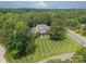 An aerial view of an estate-style home surrounded by mature trees and lush, green grass at 9202 Arlington Hills Dr, Mint Hill, NC 28227