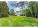 Spacious backyard with well-maintained lawn and mature trees at 9202 Arlington Hills Dr, Mint Hill, NC 28227