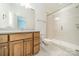 Bright bathroom featuring a classic vanity, a mirror, and a glass enclosed shower with tile surround at 9202 Arlington Hills Dr, Mint Hill, NC 28227