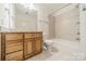 Cozy bathroom features classic vanity, a mirror, and a shower-tub combination with tile surround at 9202 Arlington Hills Dr, Mint Hill, NC 28227