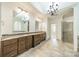 Luxurious bathroom with double vanity, granite countertops, and a glass-enclosed shower at 9202 Arlington Hills Dr, Mint Hill, NC 28227