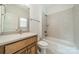 Bright bathroom features a classic vanity, a mirror, and a shower-tub combination with tile surround at 9202 Arlington Hills Dr, Mint Hill, NC 28227