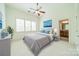 Bright bedroom with neutral tones, large windows, and an en-suite bathroom at 9202 Arlington Hills Dr, Mint Hill, NC 28227