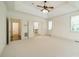 Large bedroom with tray ceiling, carpet, and adjacent bathroom at 9202 Arlington Hills Dr, Mint Hill, NC 28227