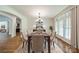 Elegant dining room with chandelier lighting, hardwood floors, and plantation shutters at 9202 Arlington Hills Dr, Mint Hill, NC 28227