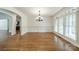 Bright dining room featuring hardwood floors, decorative wainscoting, and elegant plantation shutters at 9202 Arlington Hills Dr, Mint Hill, NC 28227