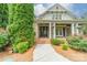 Up close exterior shot of a home featuring a brick facade, double doors, and a charming front porch at 9202 Arlington Hills Dr, Mint Hill, NC 28227