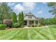 Charming home with manicured front lawn and covered front porch at 9202 Arlington Hills Dr, Mint Hill, NC 28227