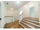 Bright hallway featuring hardwood floors, white trim, and staircase at 9202 Arlington Hills Dr, Mint Hill, NC 28227