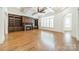 Inviting living room with built-in bookshelves, fireplace, coffered ceilings, and plantation shutters at 9202 Arlington Hills Dr, Mint Hill, NC 28227
