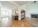 Bright living room featuring an open design, breakfast bar, modern fireplace, and ample natural light at 9202 Arlington Hills Dr, Mint Hill, NC 28227