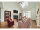 Cozy living room with fireplace, large windows, and hardwood floors at 9202 Arlington Hills Dr, Mint Hill, NC 28227