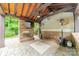 Inviting outdoor living space with stone fireplace, ceiling fan, and heater at 9202 Arlington Hills Dr, Mint Hill, NC 28227