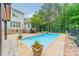 Backyard pool with elegant landscaping, spa and covered patio at 9202 Arlington Hills Dr, Mint Hill, NC 28227