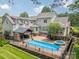 Backyard oasis with a sparkling pool, spa, outdoor kitchen, and a spacious patio perfect for entertaining at 9202 Arlington Hills Dr, Mint Hill, NC 28227